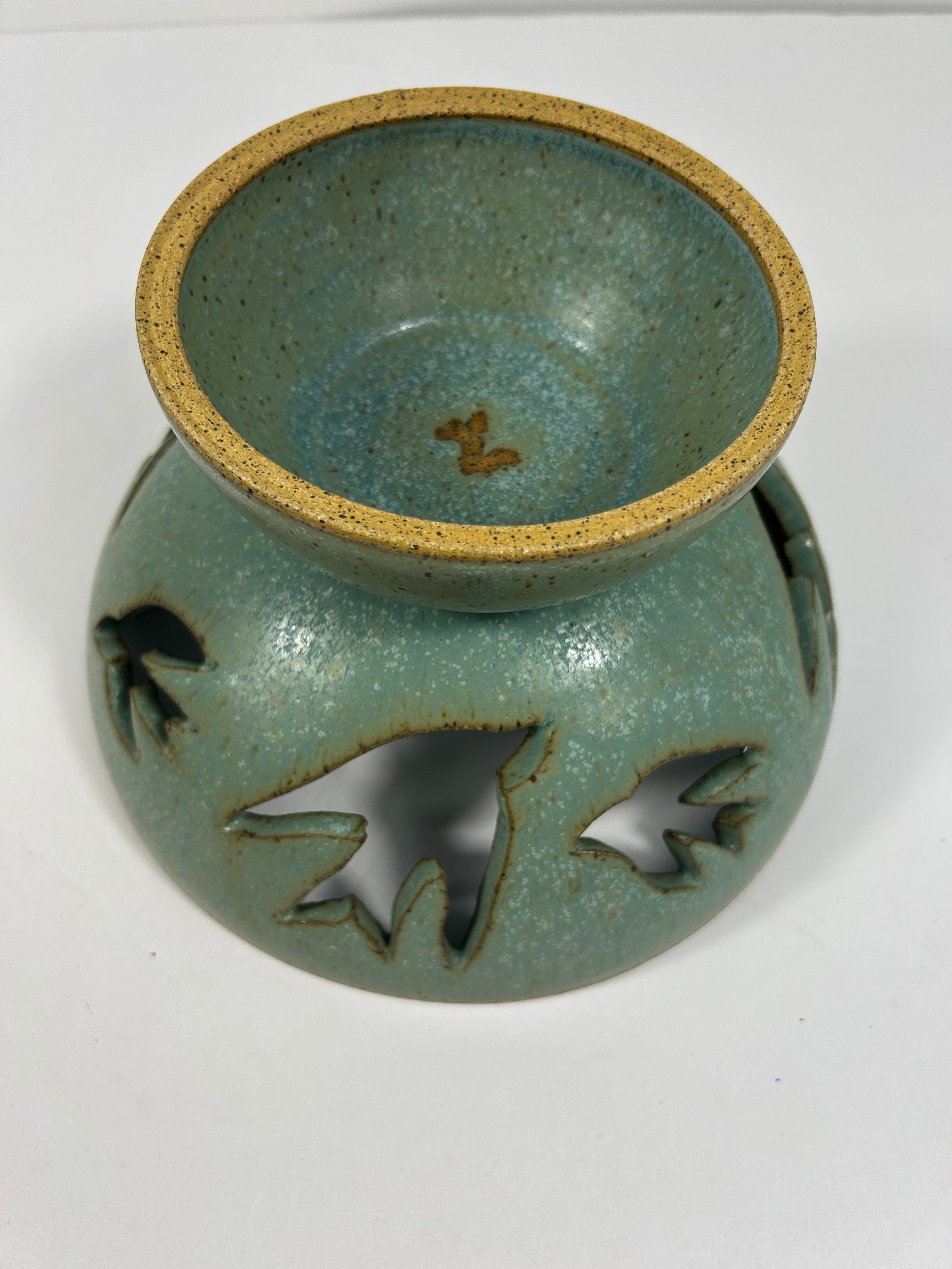 Upside down Stoneware green-blue pedestal bowl with bird piercings 
