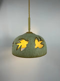 Stoneware green speckled pendant lamp with bird piercings and gold cord 