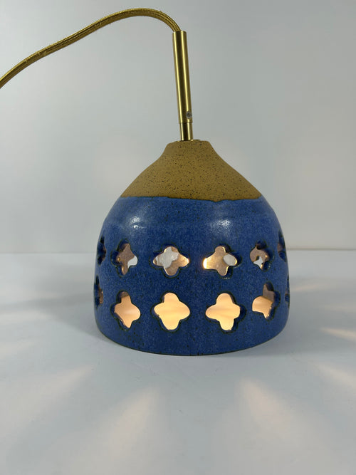 Cobalt blue ceramic pendant lamp on speckled clay with gold cord and moroccan piercings