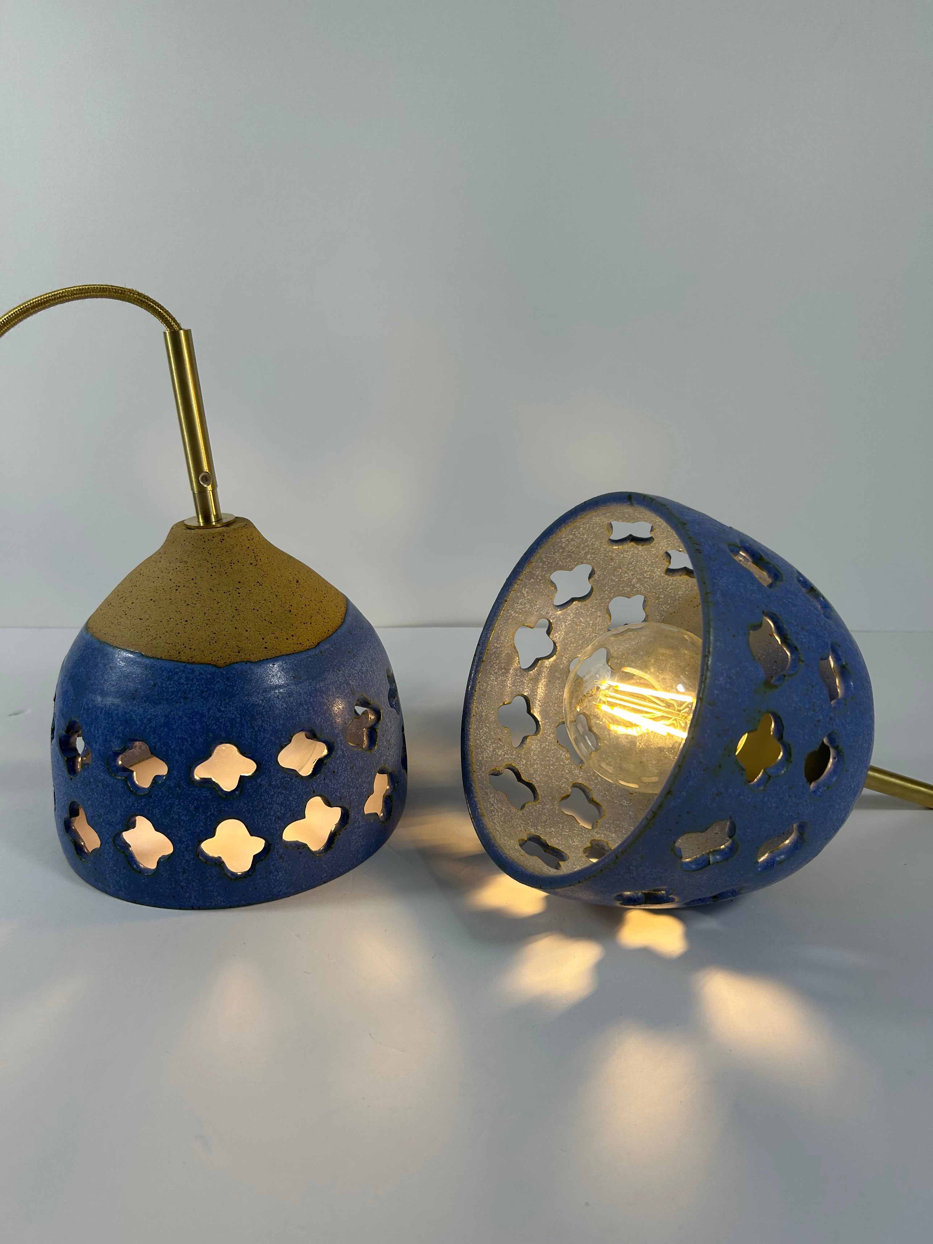 2 Cobalt blue ceramic pendant lamps on speckled clay with gold cord and moroccan piercings