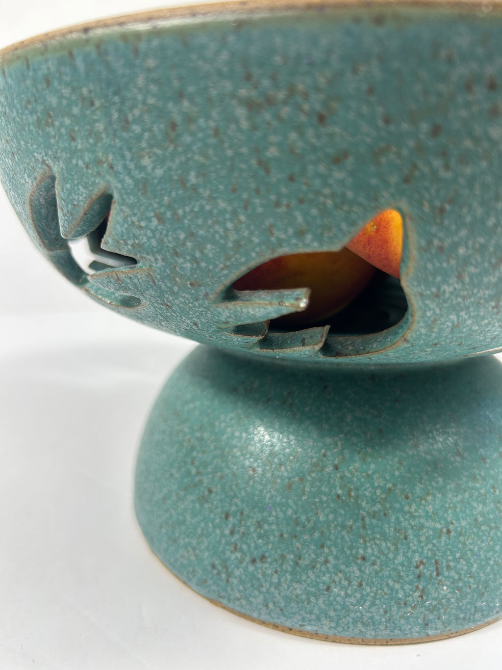 Stoneware teal pedestal bowl with swallow cut-outs