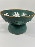 Stoneware teal pedestal bowl with swallow cut-outs 