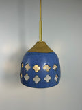Cobalt blue ceramic pendant lamp on speckled clay with gold cord and moroccan piercings